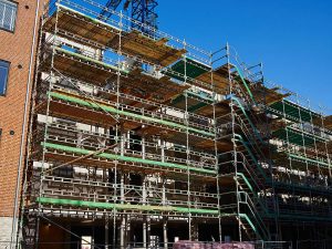 Modern construction site with scaffold platform system with a clear blue sky background